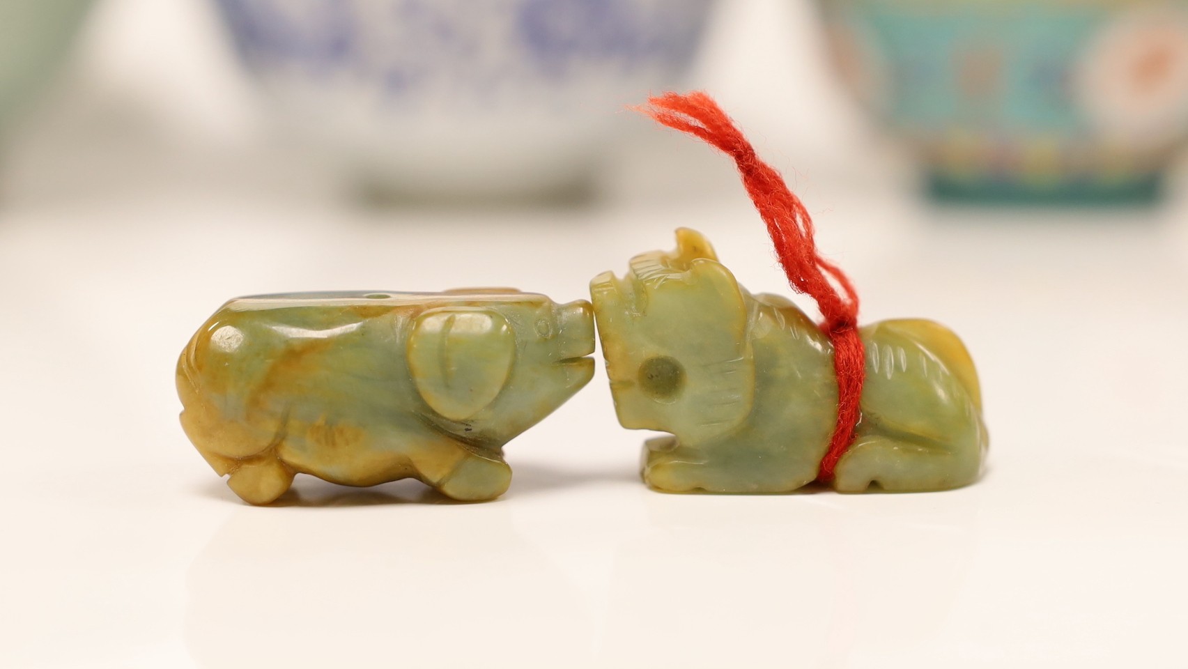 Four Oriental bowls , two hardstone pigs and a Thai carving